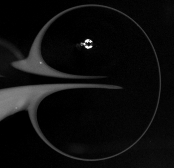 A snapshot of a electro-magnetically generated dipole in a shallow fluid layer, visualzed by dye. Image courtesy of Chun Hou Wong.